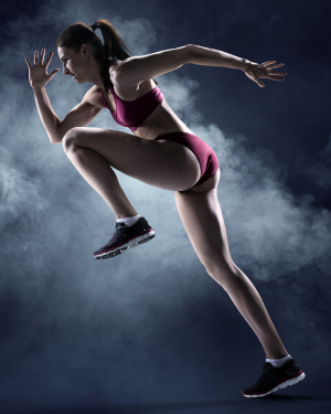 Female athlete in motion during sprint, highlighting power and speed